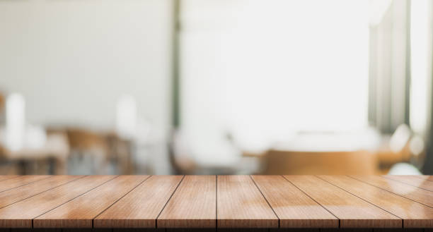 istock Empty wooden table top with lights bokeh on blur restaurant background 1346313558