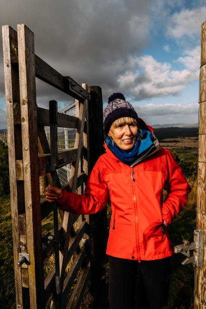 istock Woman passing through a country gate 1346315641