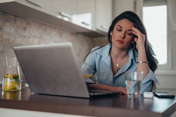 istock Businesswoman having a headache while working on a laptop at home 1346315902