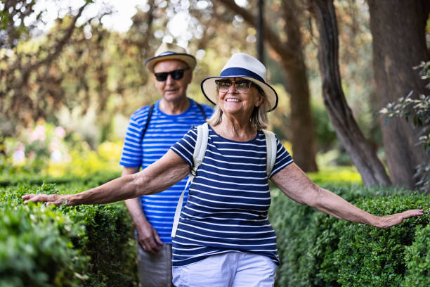 Senior couple enjoying sightseeing public park in town of Valldemosa Senior couple enjoying summer vacations. The couple is walking in the public park in the town of Valldemosa. 
Nikon D850 tourist couple candid travel stock pictures, royalty-free photos & images