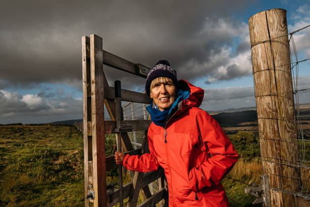 istock Woman passing through a country gate 1346317397