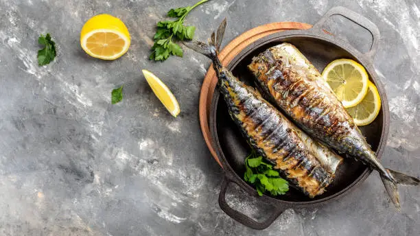 Photo of BBQ Grilled mackerel fish with herbs. Beer Fest menu. banner, menu recipe place for text, top view