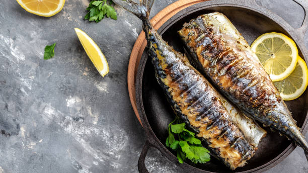 istock Beer Fest menu. Grilled mackerel fish with lemon herbs and spices, Long banner format, top view 1346318389