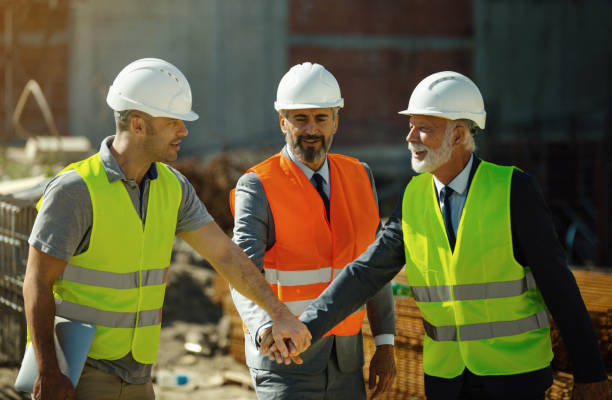 istock Group of contractors celebrating the end of successful construction process. 1346321056