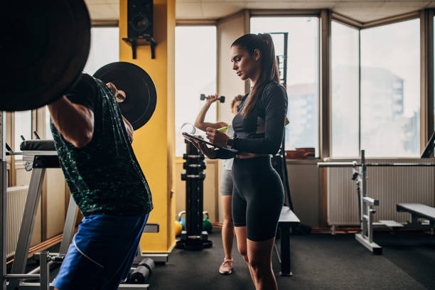 istock Fitness trainer watching a man training 1346321209