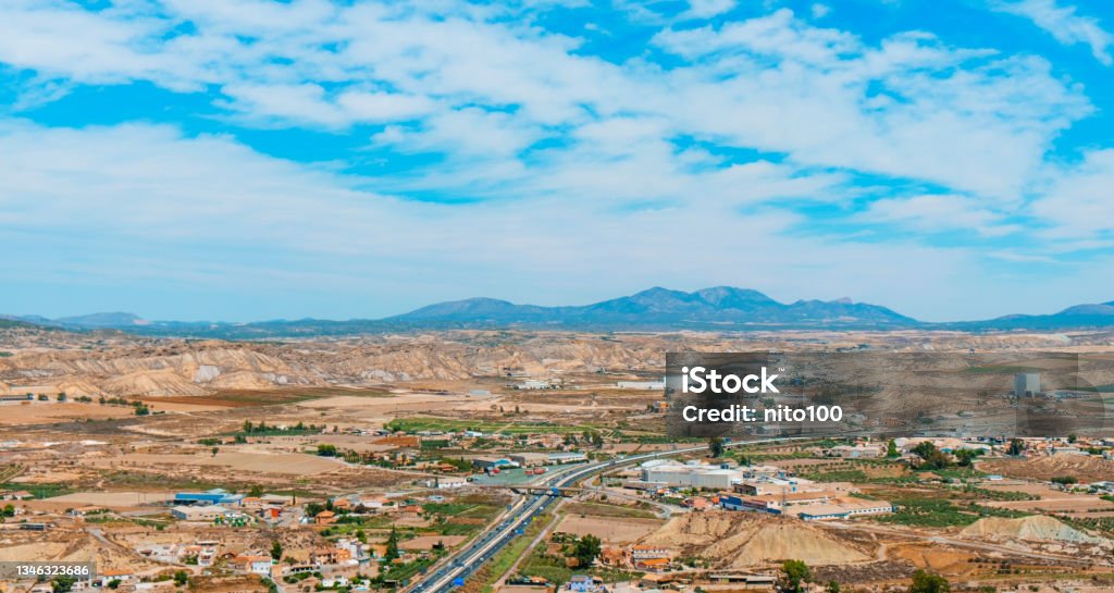 panoramic view of Lorca, in Spain a panoramic aerial view of some cultivated fields and the industrial zone of Lorca, in the Region of Murcia, Spain, highlighting the Sierra Espuna mountain range in the background Spain Stock Photo