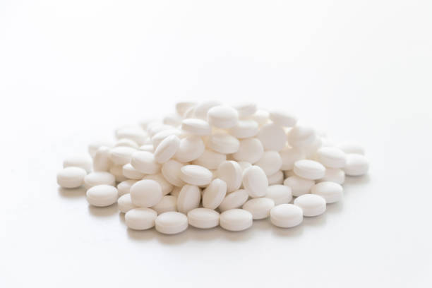 istock Lots of white tablets piled up on the table 1346323834