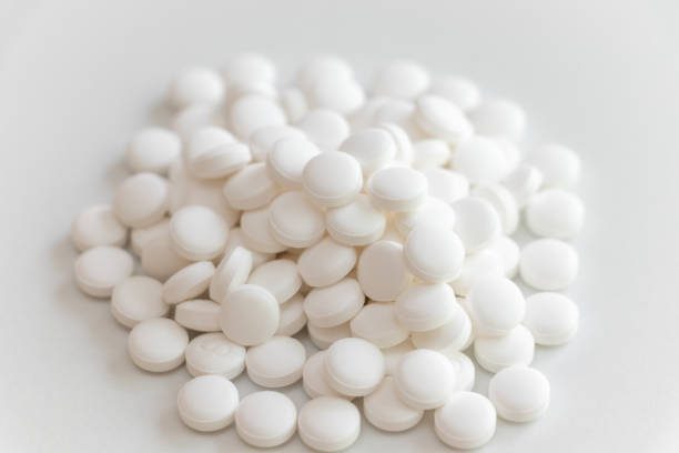 istock Lots of white tablets piled up on the table 1346323838