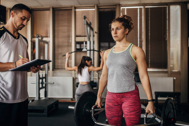 istock Personal trainer watching a woman training 1346323919