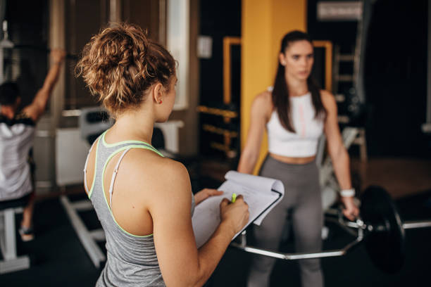 istock Fitness trainer watching a woman training 1346324810