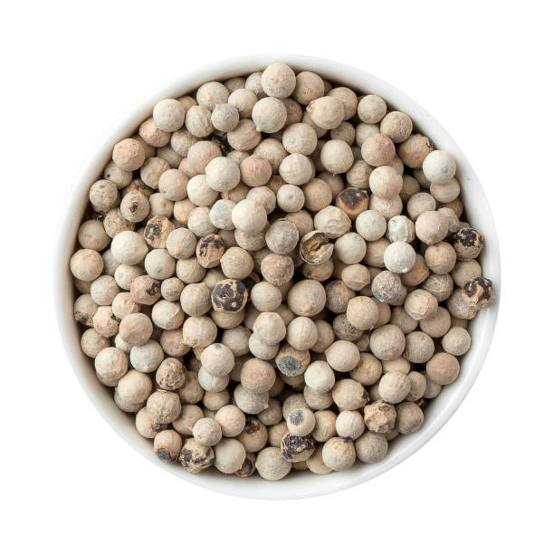 istock Isolated bowl of white peppercorns on white 1346325260