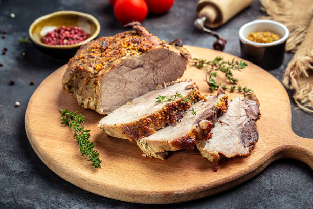istock Big Piece of Slow Cooked Oven-Barbecued Pulled Pork shoulder with thyme herb mustard on a cutting board 1346326280