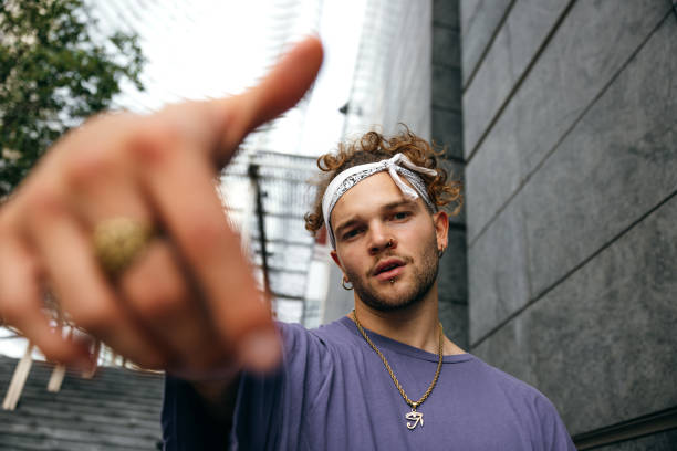 istock Alternative man dressing urban clothes posing in city downtown 1346330713