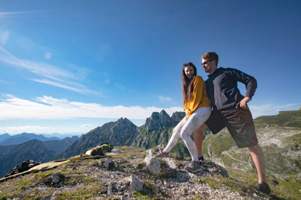 istock Smiling Young Couple Resting on Hiking Trip in Mountains 1346330913