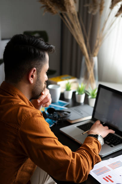 istock Young man working at home in the evening 1346331014