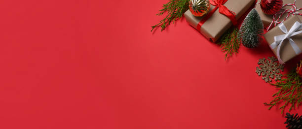 istock Gifts boxes, Christmas ornaments and fir tree branches on red background. Copy space. 1346331068