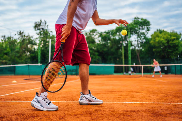 istock Young man playing tennis 1346331153