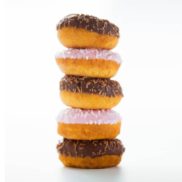istock close up of glazed donuts pile over white 1346333670