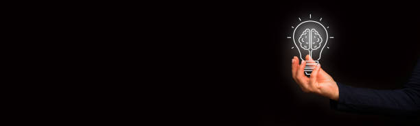 istock Hand holding an incandescent light bulb 1346335264
