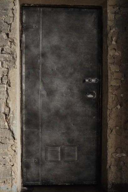 istock A close-up of an old, rusty, heavy, iron door in a brick wall. Selective focus. 1346335273
