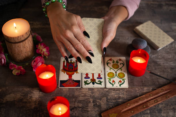 istock Fortune teller reading a future by tarot cards 1346337681