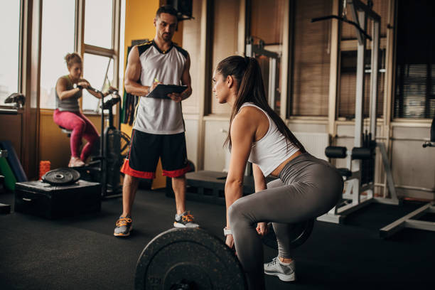 istock Fitness trainer watching a woman training 1346337718