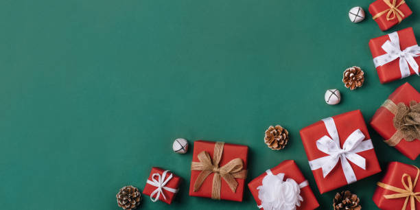 istock Gift boxes with white and brown bows on a green backdrop. 1346338246