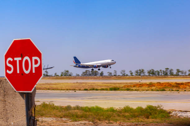 istock Passenger plane taking off from runway at airport on sunny day. 1346338353