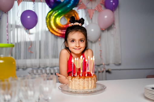 Portrait of  girl with birthday cake at home