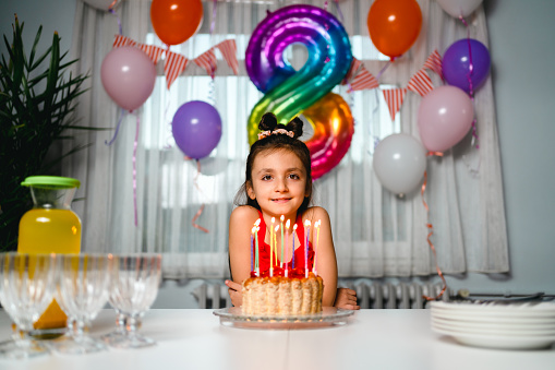 Portrait of  girl with birthday cake at home