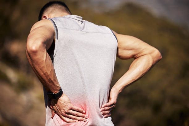 istock Shot of an unrecognizable man standing alone outside and suffering from backache during his run 1346339565