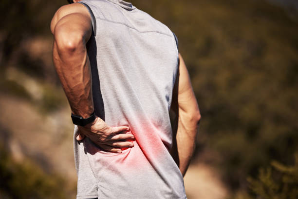istock Cropped shot of an unrecognizable man standing alone outside and suffering from backache during his run 1346339568