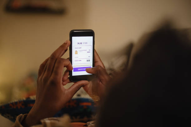 istock Young man doing online Christmas shopping on his smartphone 1346341511