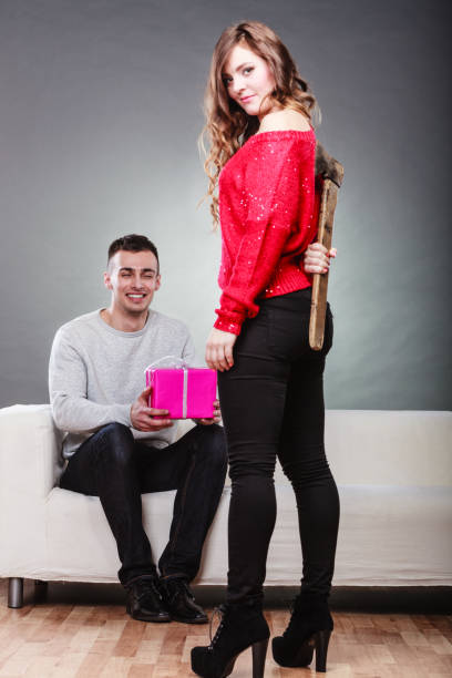 istock Trusting guy giving present to misleading girl 1346341699