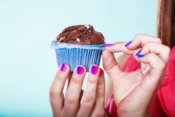 istock Sweet chocolate muffin human hands. Confectionery. 1346341780