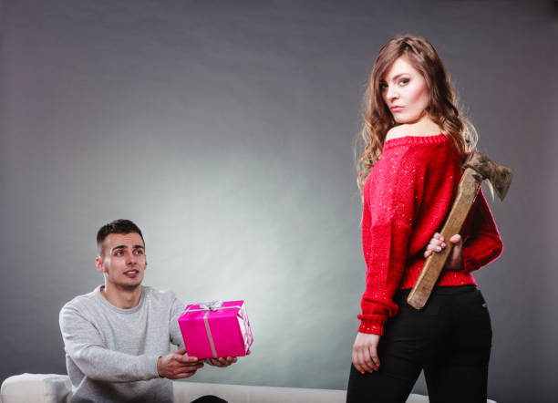 istock Trusting guy giving present to misleading girl 1346341907