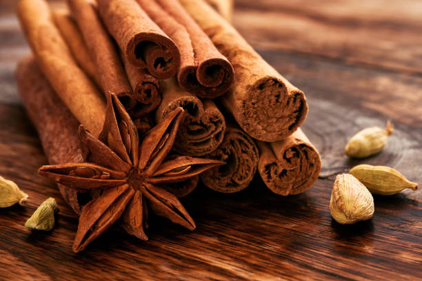 Cinnamon sticks, anise stars and cardamom on a wooden table. Set of spices for mulled wine, Christmas cake, cookies. Selective focus. close up stock photo
