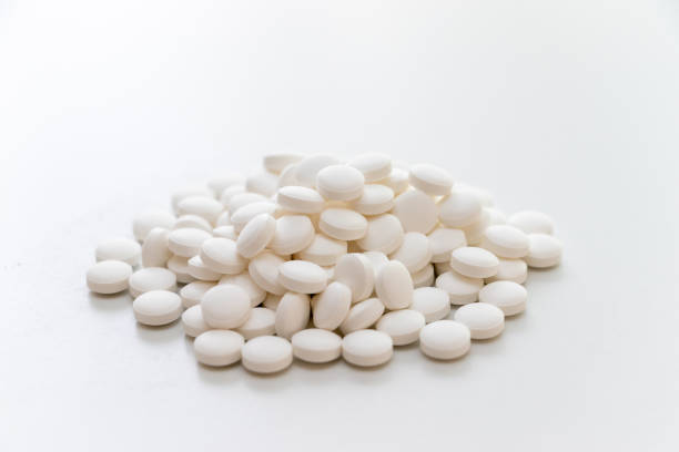istock Lots of white tablets piled up on the table 1346345753