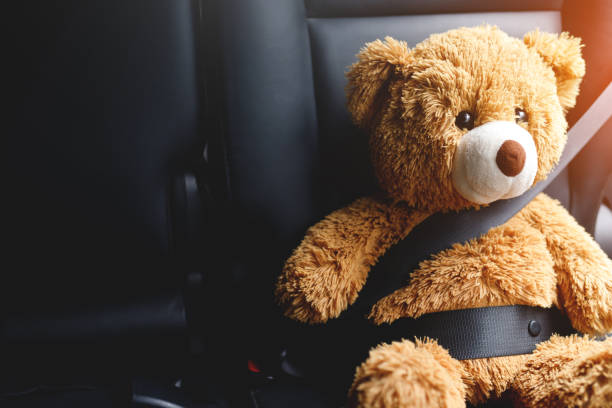 istock Brown teddy bear wearing car seat belt 1346345865