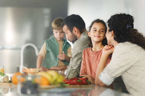 istock Family cooperating while making a meal in the kitchen. 1346346804
