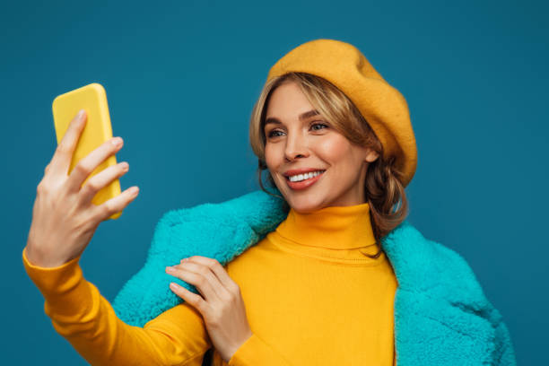 istock Beautiful emotional woman using smart phone 1346346903