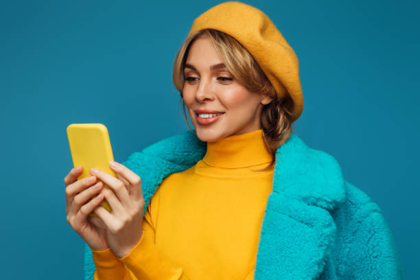 istock Beautiful emotional woman using smart phone 1346346926