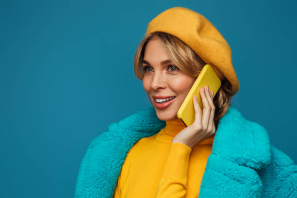 istock Beautiful emotional woman using smart phone 1346346943