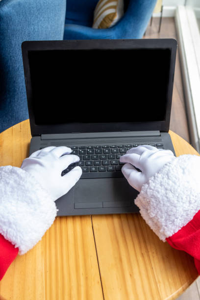 istock Santa Claus typing from his laptop 1346347213