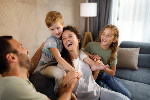 istock Cheerful family having fun while talking at home. 1346348076