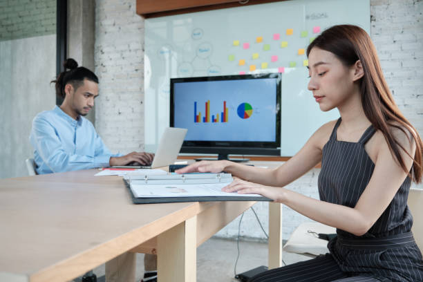 istock Two colleagues brainstorm and meeting business projects in an office. 1346349654
