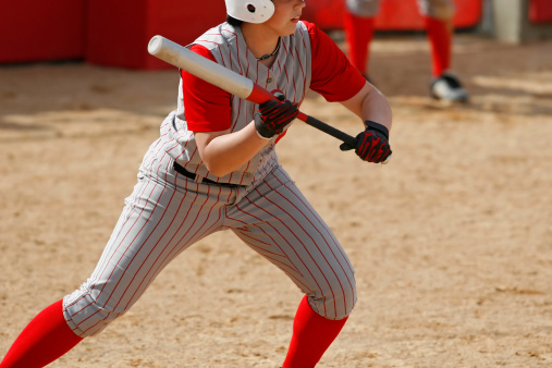 A softball player preparing to bunt.
