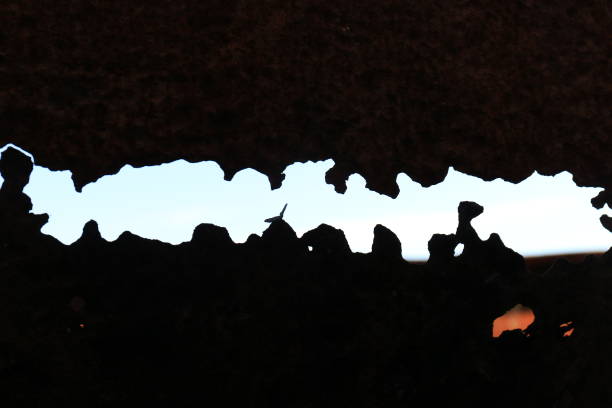 Silhouetted shapes in rusty metal stock photo