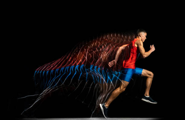 Full-length portrait of young male athlete, professional runner in motion isolated over black background. Stroboscope effect. Developing speed. Portrait of young male athlete, professional runner in motion isolated on black background. Stroboscope effect. Concept of sport, action, energy, health, movement. Copy space for ad temporal aliasing stock pictures, royalty-free photos & images