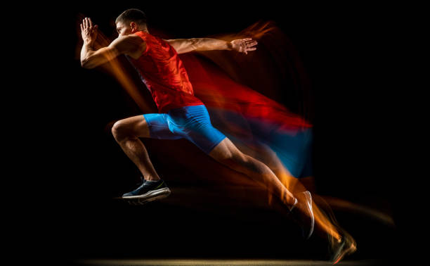 retrato recortado de joven atleta, corredor profesional entrenando aislado sobre fondo negro. efecto estroboscopio. en marcha - stroboscopic image fotografías e imágenes de stock